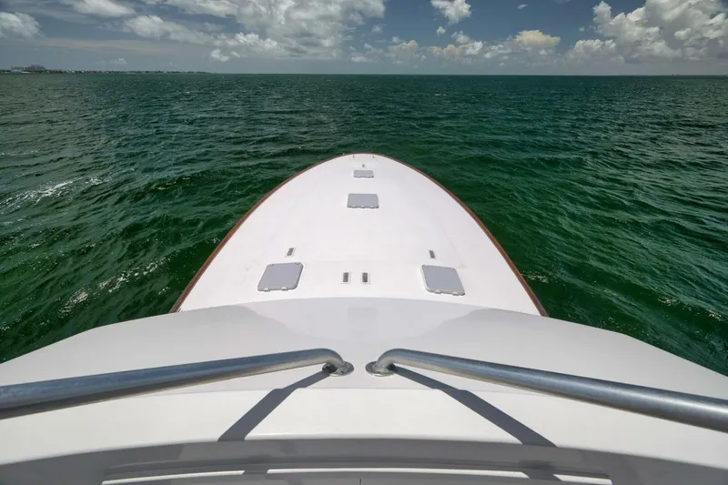 Bird Dog Yacht Photos Pics Bow of 1989 Jim Smith Custom Convertible boat on open sea under cloudy sky.