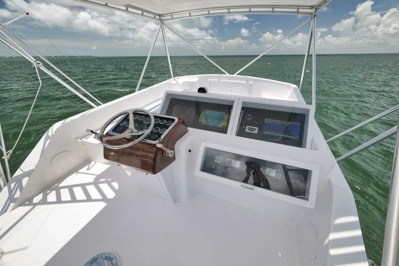Bird Dog Yacht Photos Pics 1989 Jim Smith Custom Convertible boat helm with navigation screens on open water.