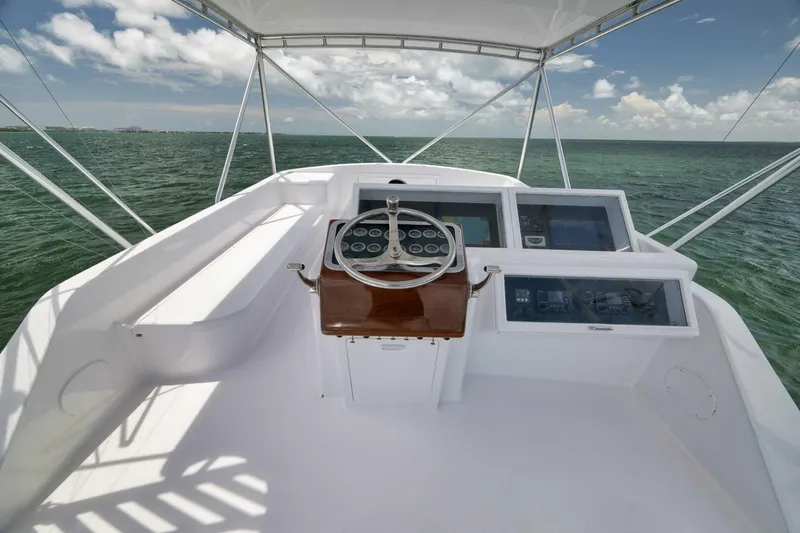 Bird Dog Yacht Photos Pics 1989 Jim Smith Custom Convertible boat helm with ocean view, featuring modern navigation equipment.