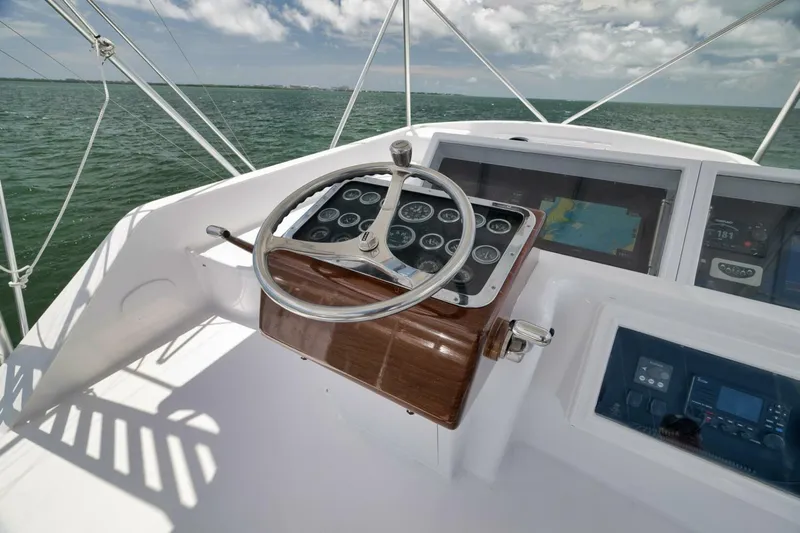 Bird Dog Yacht Photos Pics 1989 Jim Smith Custom Convertible boat helm with steering wheel and navigation instruments.