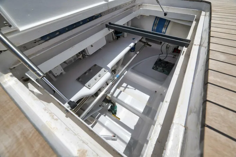 Bird Dog Yacht Photos Pics Open engine compartment of a 1989 Jim Smith Custom Convertible boat, showcasing mechanical components.