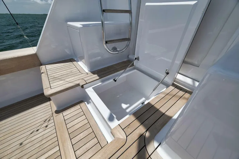 Bird Dog Yacht Photos Pics 1989 Jim Smith Custom Convertible yacht deck with open storage compartment, wooden flooring, and ocean view.