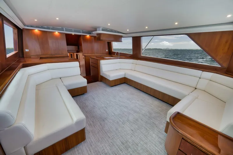 Bird Dog Yacht Photos Pics Luxurious 1989 Jim Smith Custom Convertible yacht interior with white seating and ocean view.
