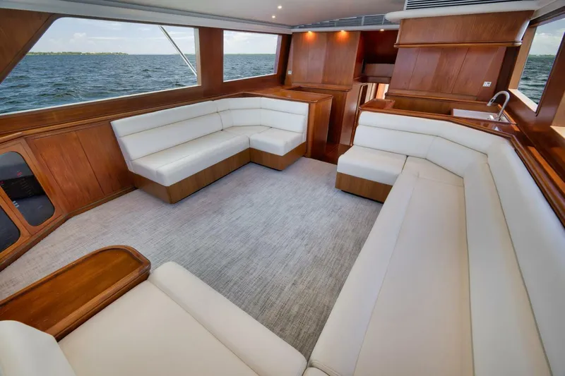 Bird Dog Yacht Photos Pics Luxurious 1989 Jim Smith Custom Convertible yacht interior with white seating and wooden accents.