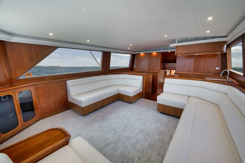 Bird Dog Yacht Photos Pics Luxurious interior of 1989 Jim Smith Custom Convertible yacht with white seating and wooden accents.