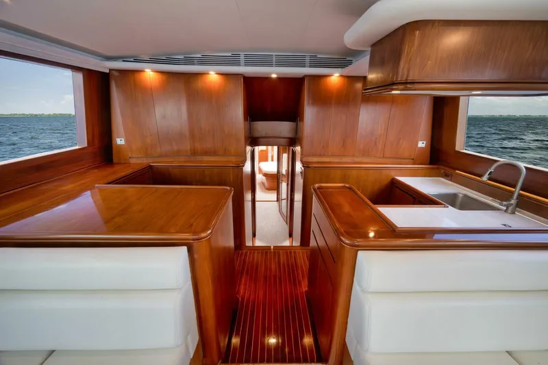 Bird Dog Yacht Photos Pics Luxurious wooden interior of a 1989 Jim Smith Custom Convertible yacht with ocean view.