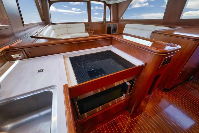 Bird Dog Yacht Photos Pics Luxurious 1989 Jim Smith Custom Convertible yacht interior with modern kitchen and seating area.