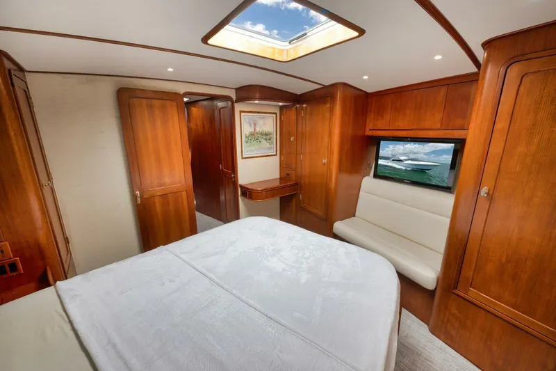 Bird Dog Yacht Photos Pics Luxurious cabin interior of 1989 Jim Smith Custom Convertible yacht with wood paneling and skylight.