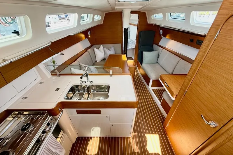 Spectre Yacht Photos Pics Luxurious interior of 2016 X-Yachts Xp38 sailboat with modern kitchen and seating area.