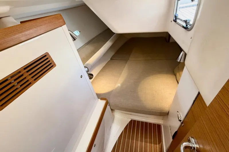 Spectre Yacht Photos Pics Cozy cabin interior of 2016 X-Yachts Xp38 with wooden accents and comfortable bedding.