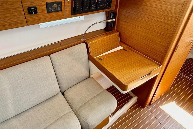 Spectre Yacht Photos Pics Interior of 2016 X-Yachts Xp38 sailboat with wooden desk and cushioned seating.