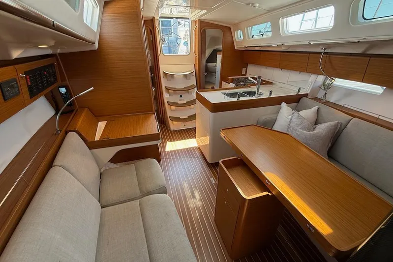 Spectre Yacht Photos Pics Interior of 2016 X-Yachts Xp38 sailboat with modern wood finish and cozy seating.