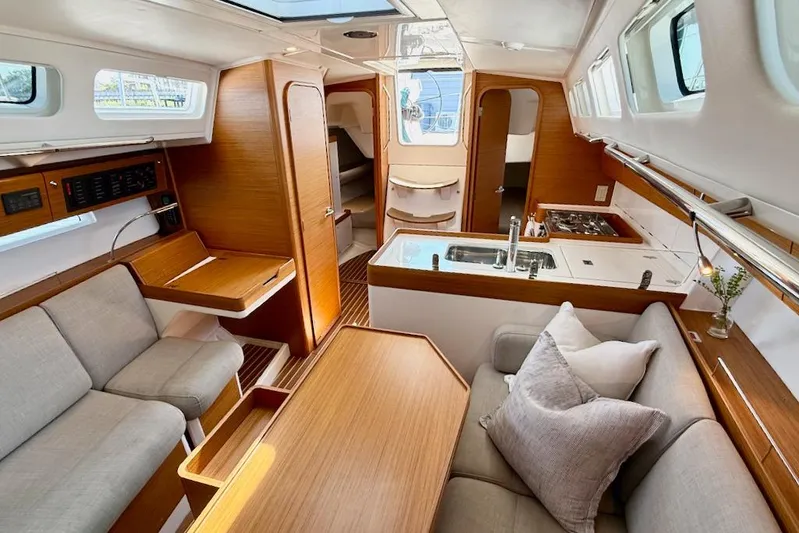 Spectre Yacht Photos Pics Luxurious interior of 2016 X-Yachts Xp38 sailboat with modern kitchen and seating area.