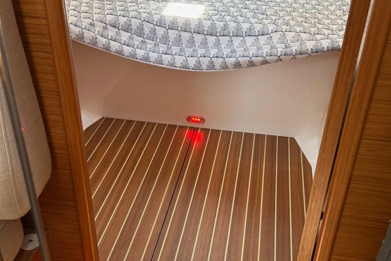 Spectre Yacht Photos Pics Interior of 2016 X-Yachts Xp38 with wooden flooring and patterned bedding.