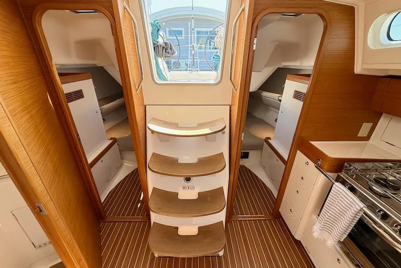 Spectre Yacht Photos Pics Interior of 2016 X-Yachts Xp38 sailboat with wooden finish and compact kitchen.