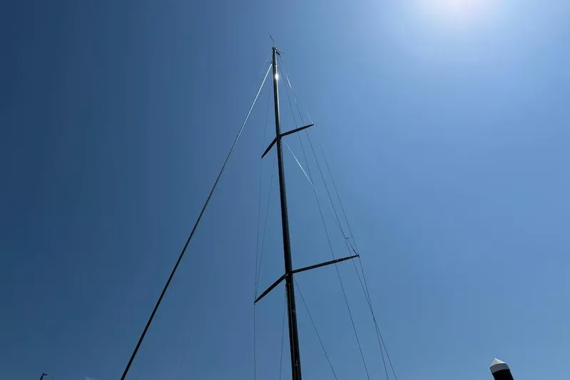 Spectre Yacht Photos Pics Tall mast of 2016 X-Yachts Xp38 sailboat against clear blue sky.