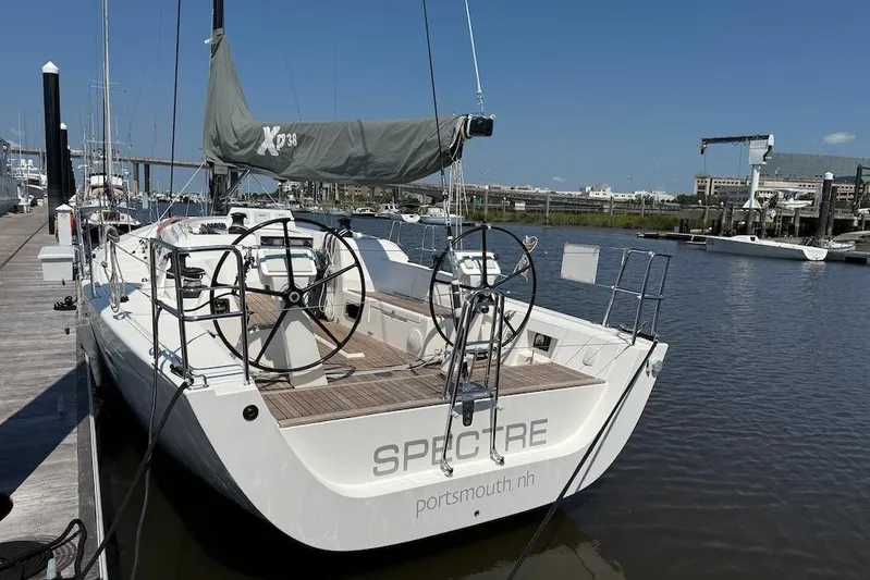 Spectre Yacht Photos Pics 2016 X-Yachts Xp38 sailboat docked in a marina, featuring dual steering wheels.