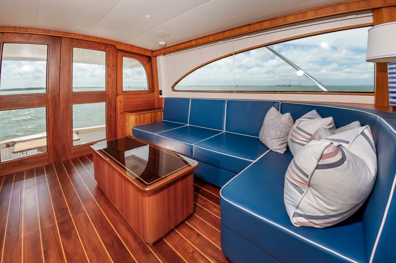 Privateer Yacht Photos Pics Interior of 2019 Jarrett Bay 67 Custom yacht with blue leather couch.