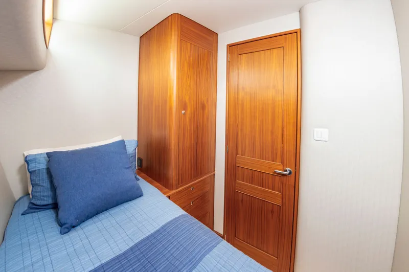 Privateer Yacht Photos Pics 2019 Jarrett Bay 67 Custom yacht cabin interior with wooden door.