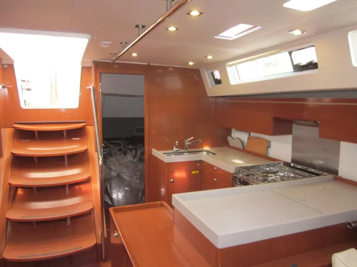 Cameli Yacht Photos Pics Interior of 2020 Beneteau Oceanis 55.1 yacht, featuring modern kitchen and wooden cabinetry.