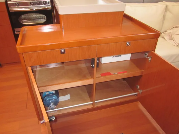 Cameli Yacht Photos Pics Interior of 2020 Beneteau Oceanis 55.1 yacht showing wooden cabinetry and storage space.