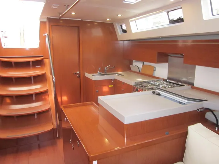 Cameli Yacht Photos Pics Luxurious interior of 2020 Beneteau Oceanis 55.1 yacht with modern kitchen and wooden finishes.