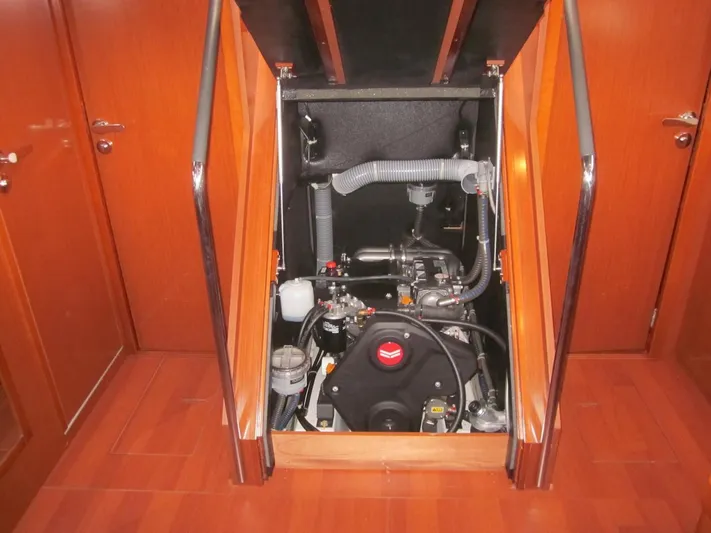 Cameli Yacht Photos Pics Engine compartment of 2020 Beneteau Oceanis 55.1 sailboat, showcasing mechanical components and wooden interior.