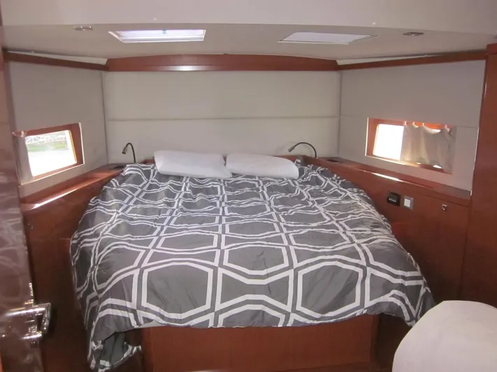 Cameli Yacht Photos Pics Interior cabin of 2020 Beneteau Oceanis 55.1 yacht with a cozy bed.