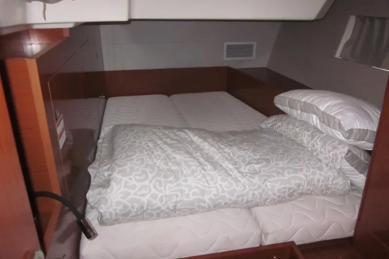 Cameli Yacht Photos Pics Cozy cabin interior of 2020 Beneteau Oceanis 55.1 yacht with comfortable bedding.