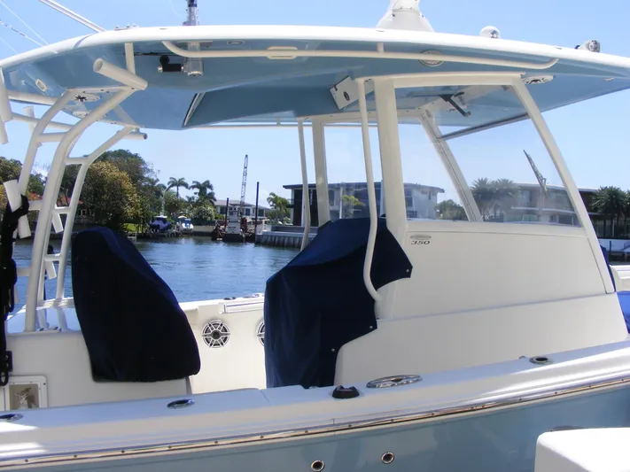  Yacht Photos Pics 2020 Cobia 350 Center Console boat docked, featuring covered seats and a clear view of the waterway.