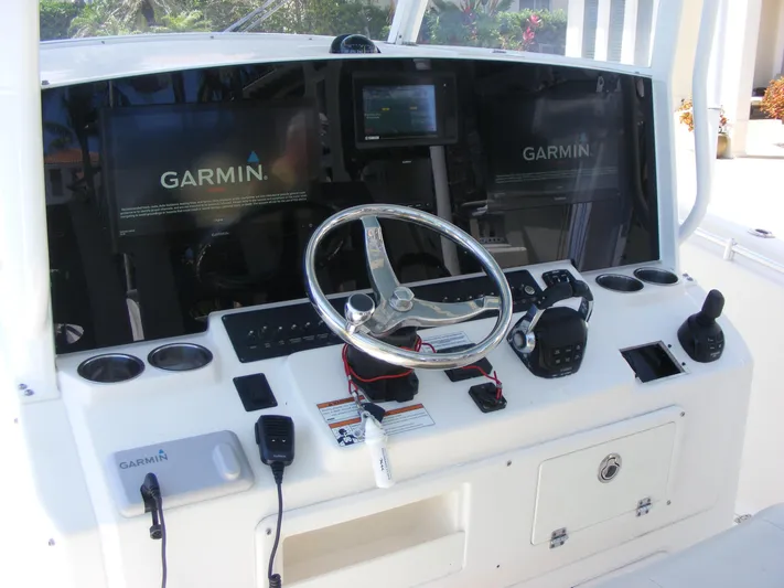  Yacht Photos Pics 2020 Cobia 350 Center Console dashboard with Garmin navigation displays and steering wheel.