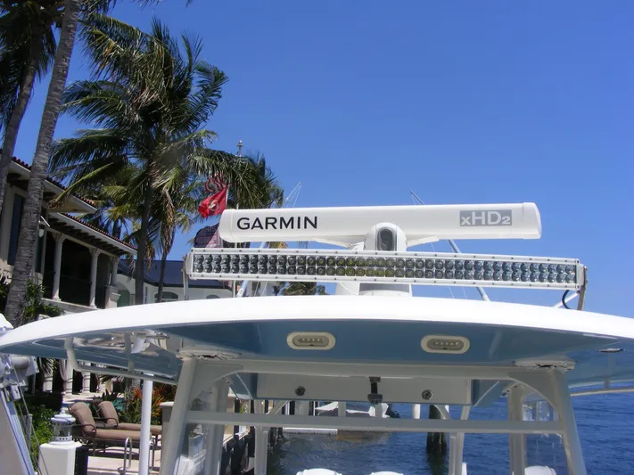  Yacht Photos Pics 2020 Cobia 350 Center Console with Garmin radar, docked near palm trees and waterfront homes.