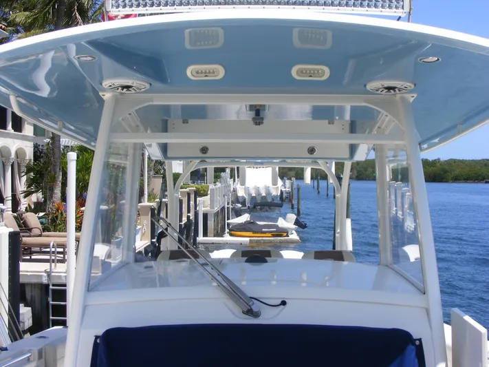  Yacht Photos Pics 2020 Cobia 350 Center Console boat docked by waterfront homes.