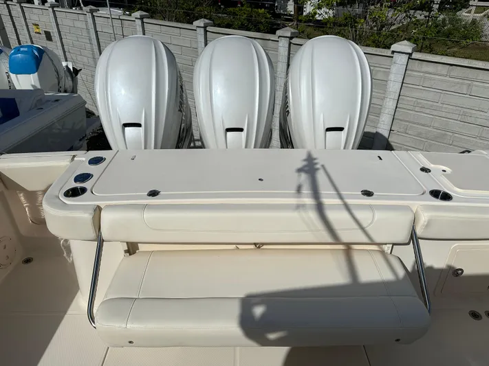  Yacht Photos Pics 2023 Grady-White Canyon 376 boat with triple outboard engines and seating area.