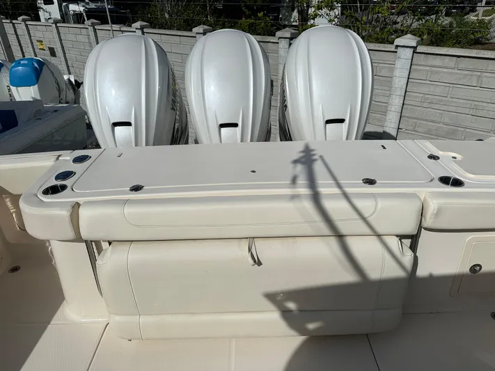  Yacht Photos Pics 2023 Grady-White Canyon 376 boat with triple outboard engines, docked outdoors.