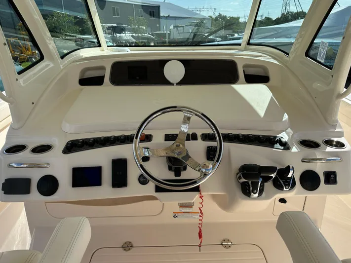  Yacht Photos Pics 2023 Grady-White Canyon 376 helm with steering wheel and controls.