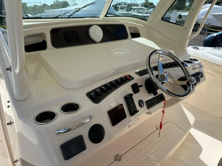  Yacht Photos Pics 2023 Grady-White Canyon 376 boat dashboard with steering wheel and control panel.