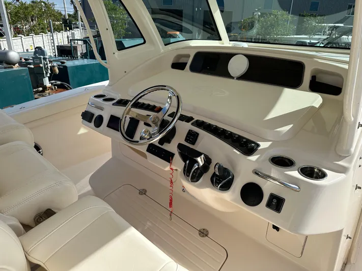  Yacht Photos Pics 2023 Grady-White Canyon 376 boat helm with steering wheel and control panel.