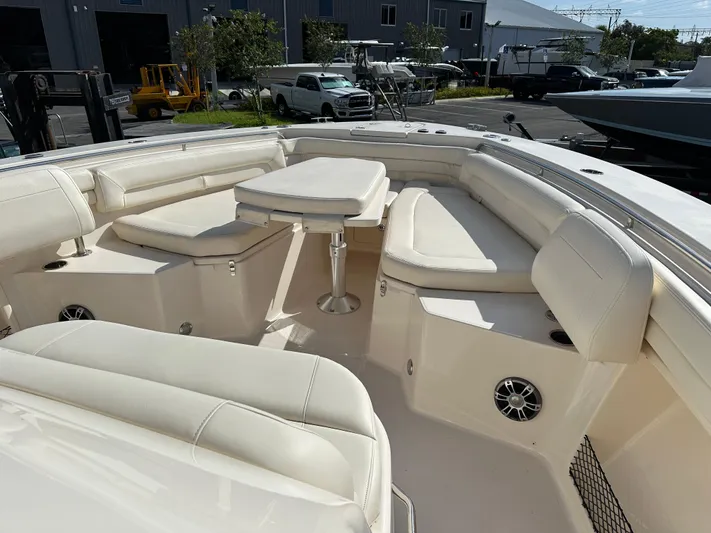  Yacht Photos Pics 2023 Grady-White Canyon 376 boat interior with cushioned seating and table.