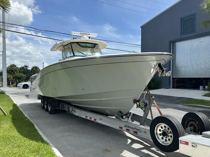  Yacht Photos Pics 2023 Grady-White Canyon 376 boat on trailer outside a building.