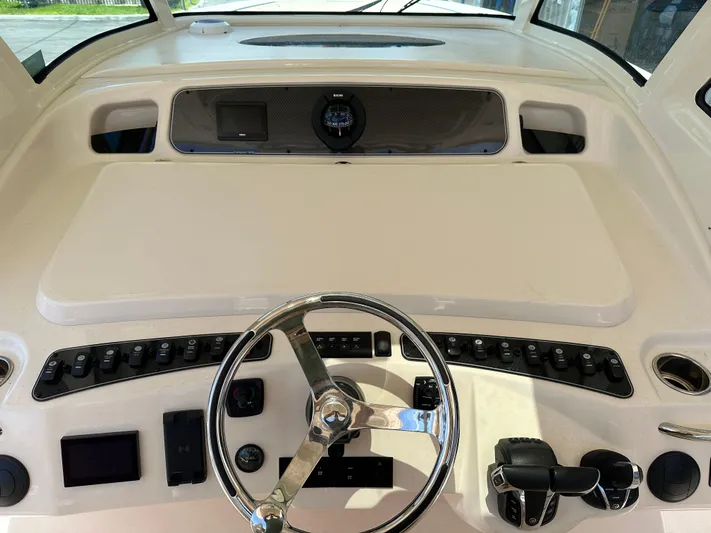 Yacht Photos Pics 2023 Grady-White Canyon 376 helm with steering wheel and control panel.