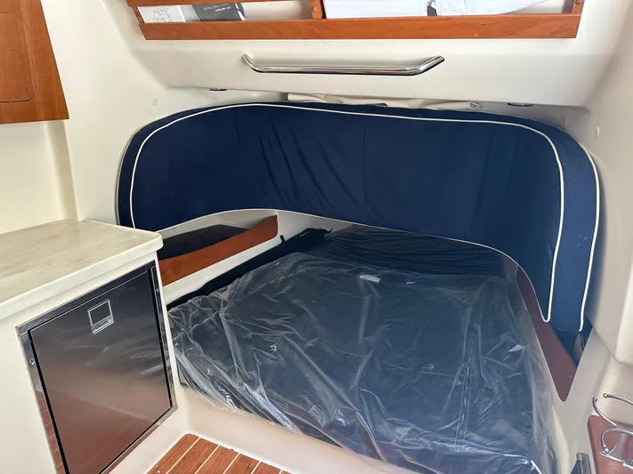 Yacht Photos Pics 2023 Grady-White Canyon 376 cabin interior with bed and mini fridge.