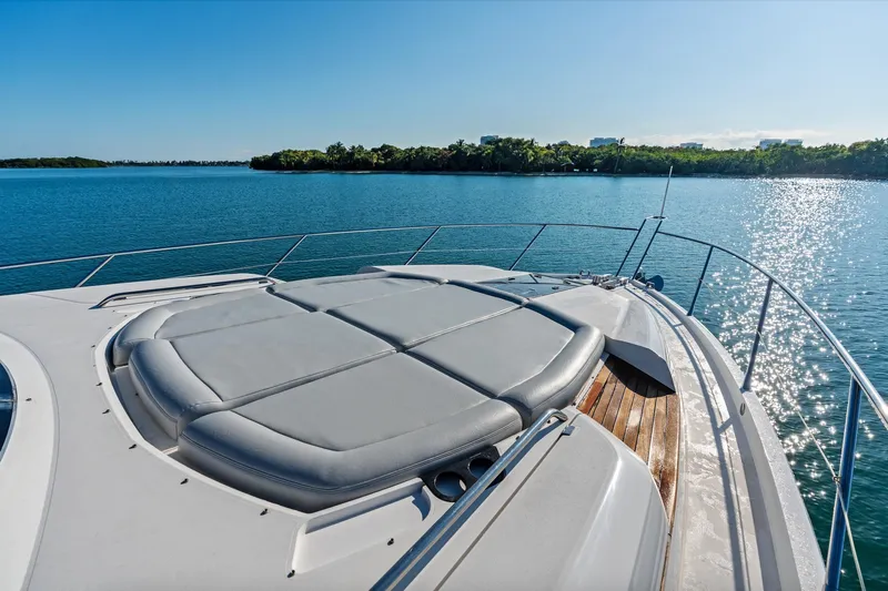 Gem Yacht Photos Pics Sunseeker 68 Sport Yacht 2014 on serene water, featuring spacious sunbathing deck.