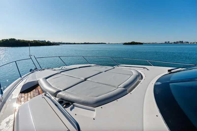 Gem Yacht Photos Pics Sunseeker 68 Sport Yacht 2014 on serene blue waters, featuring spacious sunbathing area.