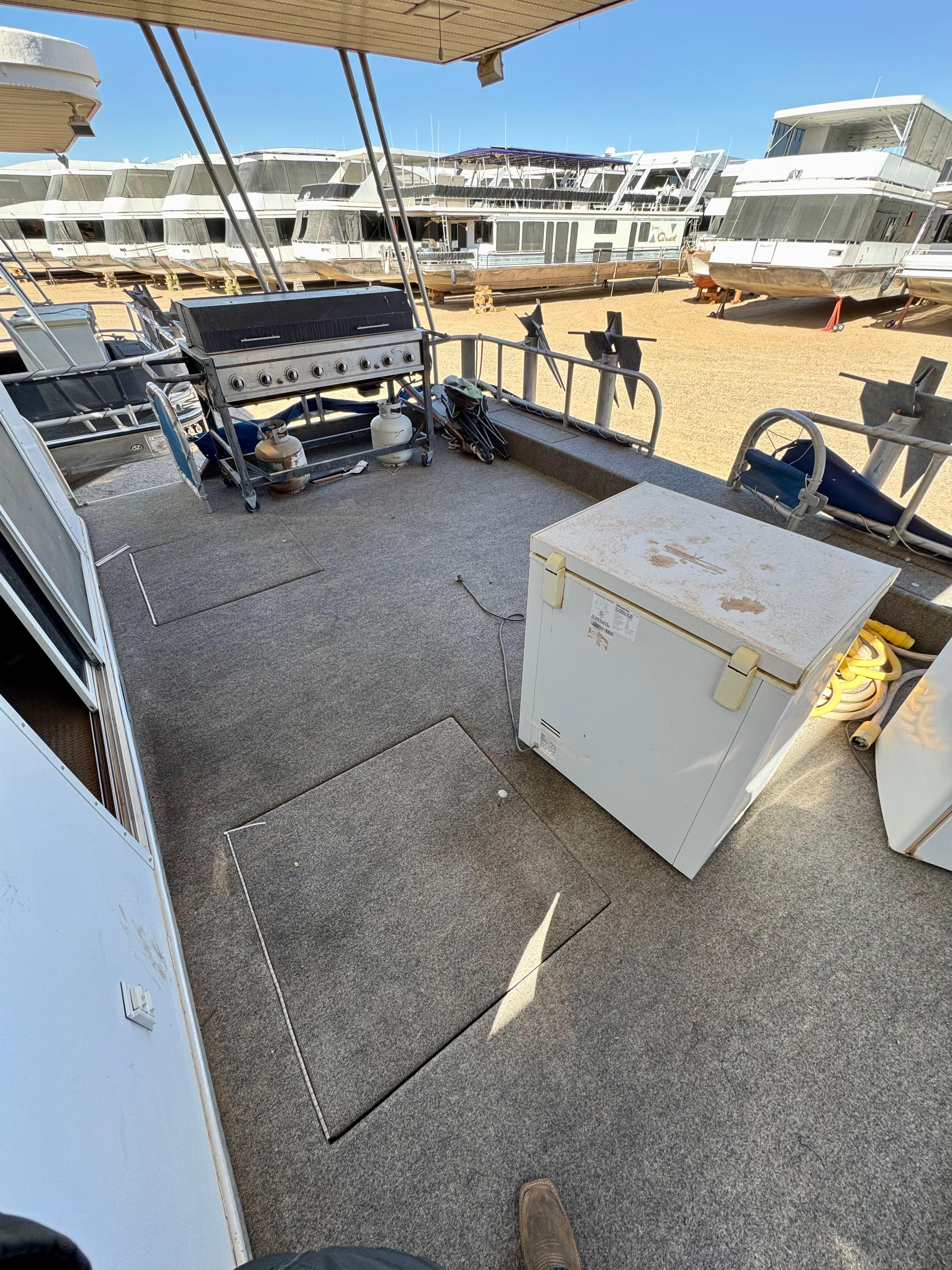 1993 Lakeview Full Ownership boat deck with grill and storage box, docked in a marina.
