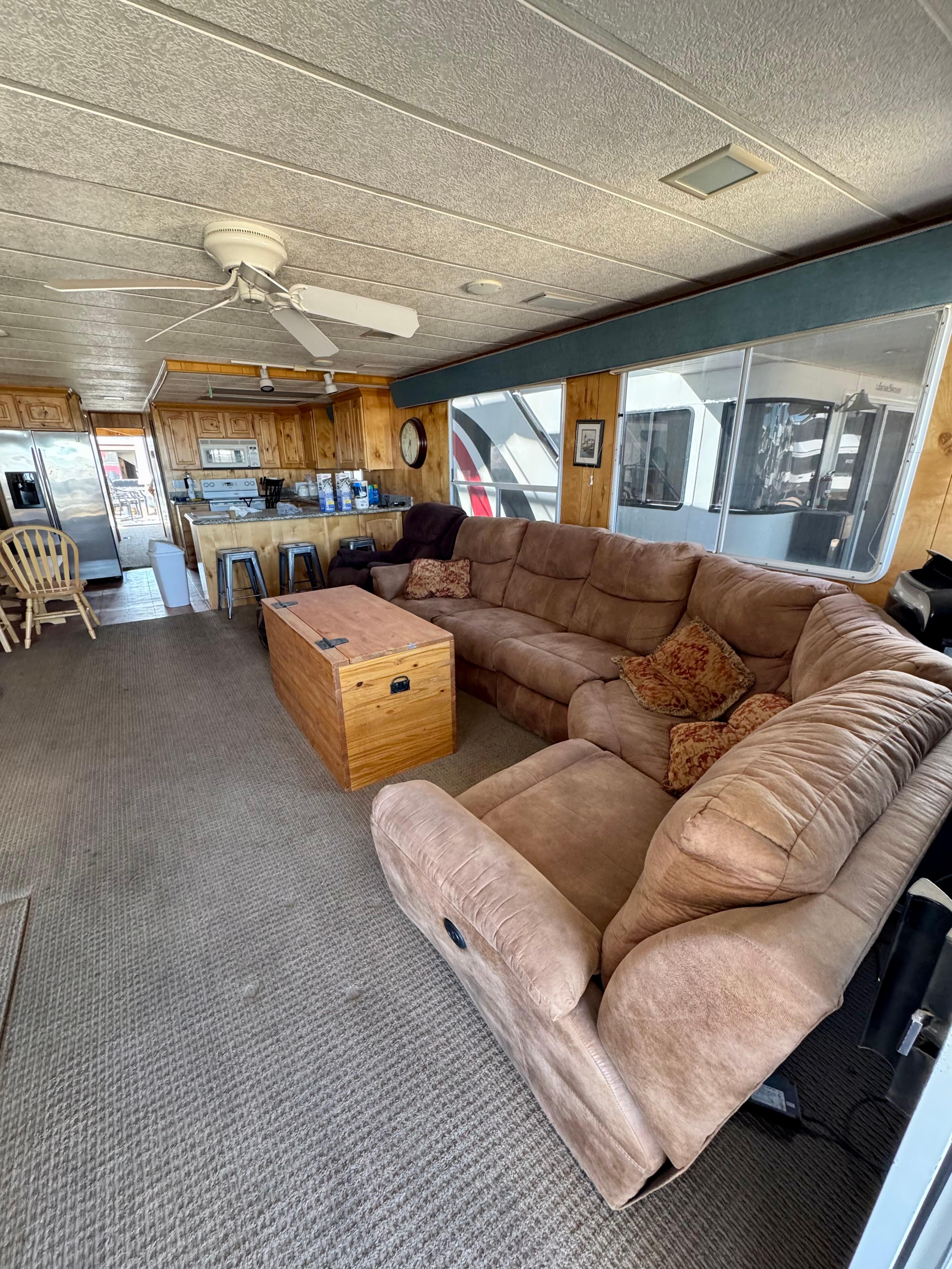 Spacious 1993 Lakeview houseboat interior with cozy seating and kitchen area.