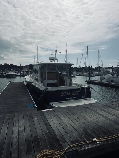 Someday Yacht Photos Pics 2012 Back Cove 34 boat docked at marina under cloudy sky.