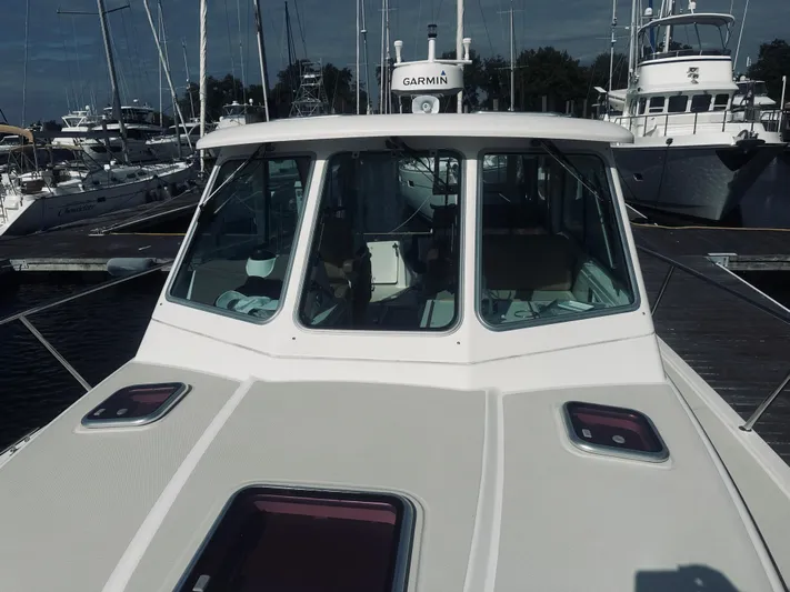 Someday Yacht Photos Pics 2012 Back Cove 34 boat docked at marina, front view with windows and hatches.