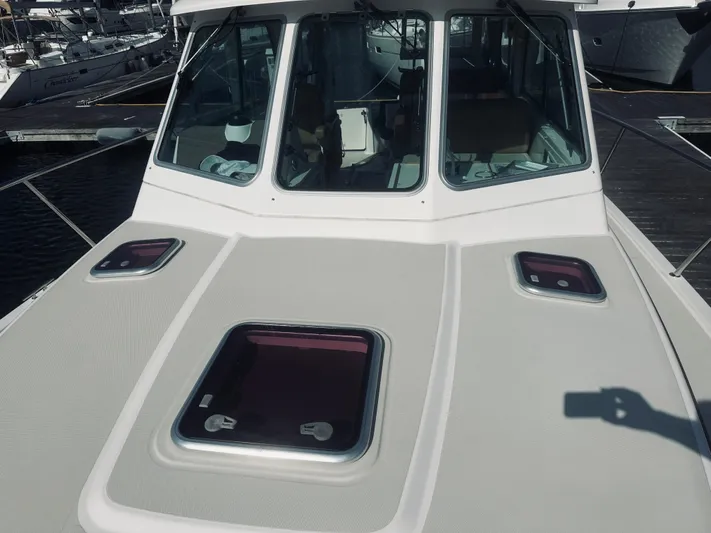 Someday Yacht Photos Pics 2012 Back Cove 34 boat deck with windows, docked at marina.