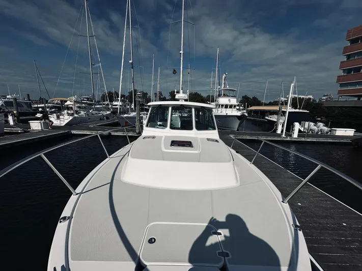 Someday Yacht Photos Pics 2012 Back Cove 34 boat docked at marina under cloudy sky.